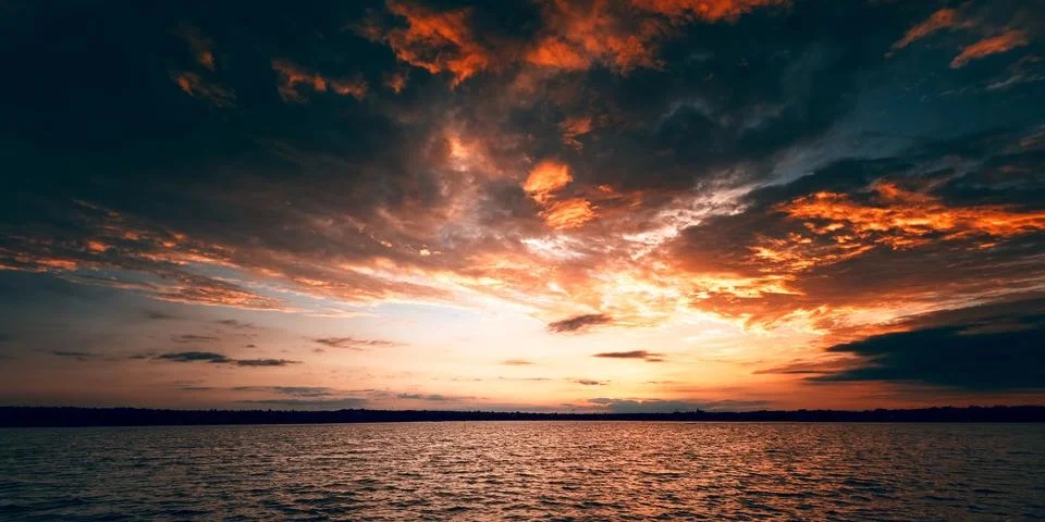 Fiery Dramatic Sunset Over Wide River Stock Photos