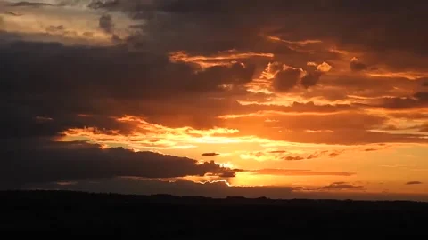 Fiery Dramatic Sunset Sky With Vibrant Orange Clouds And Silhouette Horizon Stock Footage 323106948