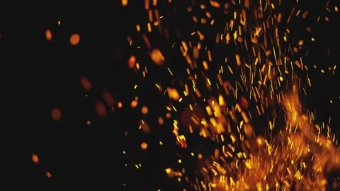 Fiery embers floating upwards from a bonfire against a dark black backgroun.. Stock Footage 337613615