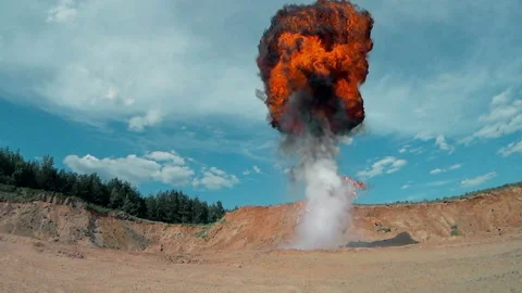 Fiery explosion with a rising cloud of smoke.  Nuclear Stock Footage 91916577