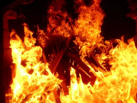 Fiery flame of fire on a black background close up Stock Photos