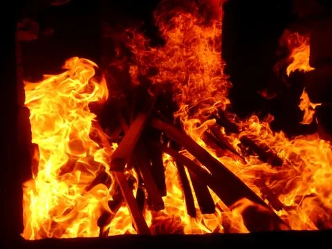Fiery flame of fire on a black background close up Stock Photos