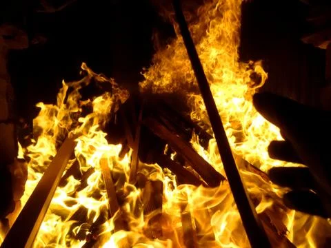 Fiery flame of fire on a black background close up Stock Photos