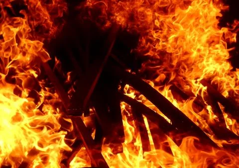 Fiery flame of fire on a black background close up Stock Photos
