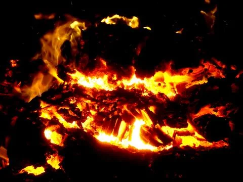 Fiery flame of fire on a black background close up Stock Photos