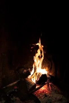 Fiery flames of a burning fire in a fireplace Stock Photos
