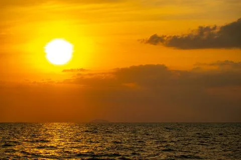 Fiery horizon, dramatic ocean sunset in vibrant hues over dark waters, natu.. Stock Photos