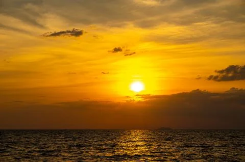 Fiery horizon, dramatic ocean sunset in vibrant hues over dark waters, natu.. Stock Photos