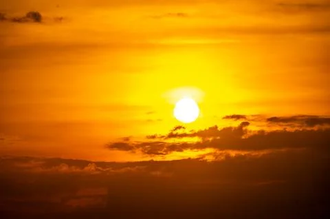 Fiery horizon, dramatic ocean sunset in vibrant hues over dark waters, natu.. Stock Photos