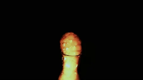 Fiery Orange Foam Coming Out of the Glass Vessel in Darkness Stock Footage 60847554