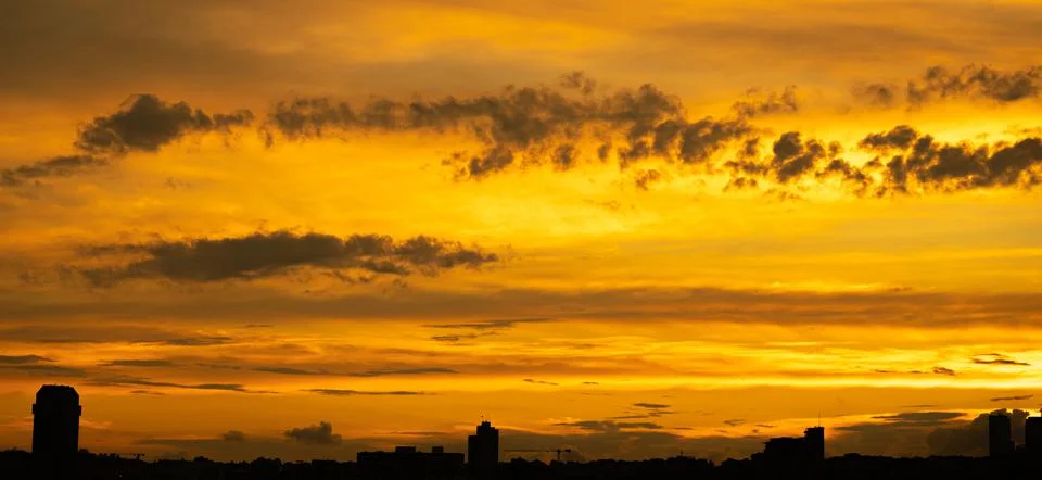 Fiery orange sky with clouds sunset in the east Stock Photos