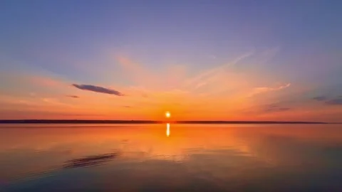 Fiery Orange Sunset Mirror Reflection on Calm Lake Stock Footage 344818851