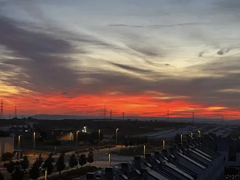 Fiery orange sunset over rows of townhouses in El Cañaveral, Madrid Stock Photos