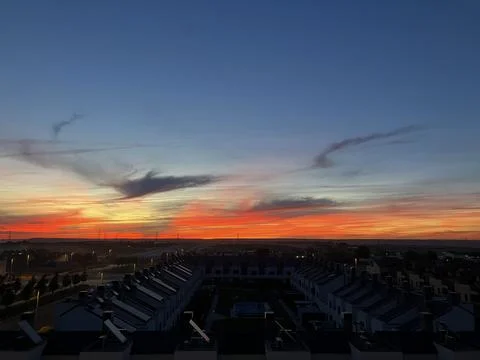 Fiery orange sunset over rows of townhouses in El Cañaveral, Madrid Stock Photos