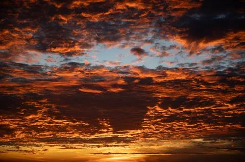 Fiery orange sunset sky in background. Stock Photos