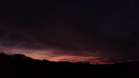 Fiery, peaceful sunset, sideward movement before silhouette of trees, drone shot 스톡 동영상 140220796