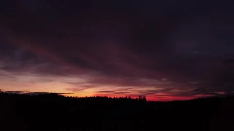 Fiery, peaceful sunset, sideward movement before Silhouette of trees, drone shot 스톡 동영상 140221059