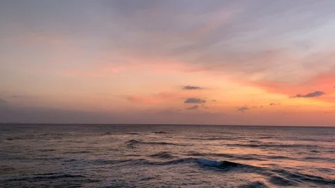 Fiery pink sunset with waves breaking over rocks Okinawa Japan Stock-Footage 125427503