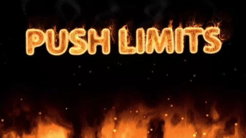 Fiery Push Limits Text with Ground Flames and Embers on Black Stock Footage 345206532