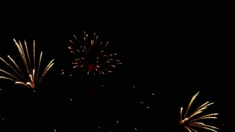 Fiery rays with golden sparks of fireworks adorn black night sky, slow motion. Stock Footage 202287221