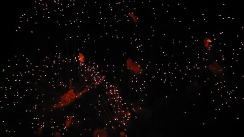 Fiery red and pink shining fireworks flashes on the black night sky. Medium.. Stock Footage 256926091