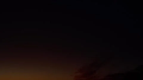 Fiery red cirrus clouds at sunset against a deepening blue sky, timelapse Stock Footage 341168568