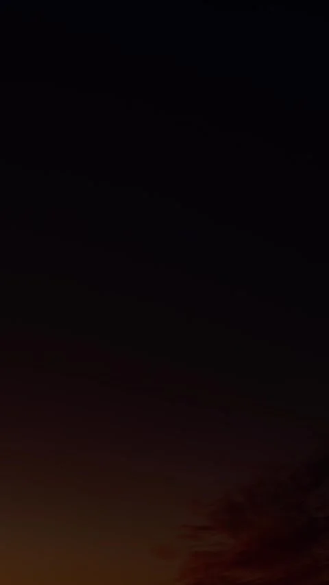 Fiery red cirrus clouds at sunset against a deepening blue sky, timelapse Stock Footage 341367732