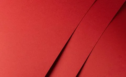 Fiery red paper background with overlapping diagonal sheets. Bold warm tones, Foto stock