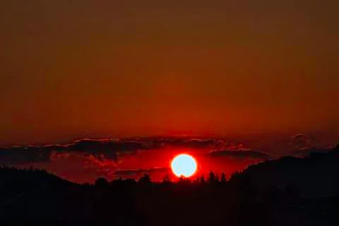 A fiery red sunset during a winter evening in the bormida valley 库存照片