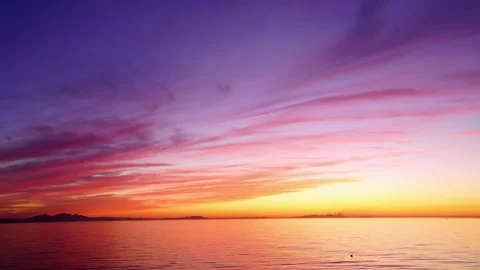 Fiery red sunset glow makes half of sky red, reflected on lake. Time-lapse Stock Footage 159575877