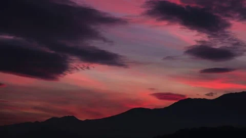 Fiery red sunset sky over mountains. Dramatic sunset sky with mountains. Stock Footage 296058062