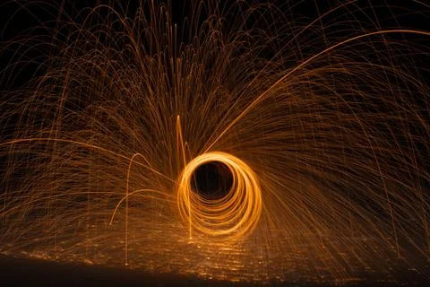 Fiery Ring of Light Explodes into Sparks in Dark Winter Night Stock Photos