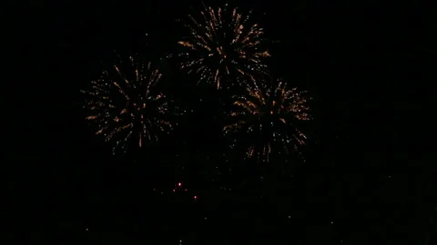 Fiery scattering of festive fireworks in the night sky above the river reflected Stockbeeldmateriaal 120815559