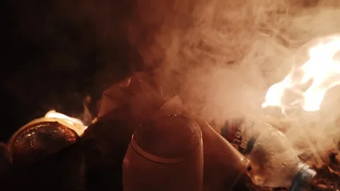 Fiery Scene with Burning Smoke and Plastic Waste in Dark Ambiance Stock Footage 308174696