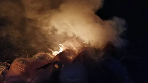 Fiery Scene with Burning Smoke and Plastic Waste in Dark Ambiance Stock Footage 308174735