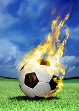 Fiery soccer ball on grass Stock Illustration