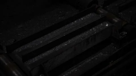 Fiery steel sweeps through black machines. Plant for the production of metal. Stock-Footage 101781916