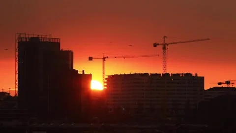 Fiery sunset behind the silhouettes of city high-rise buildings Stock Footage 259245665