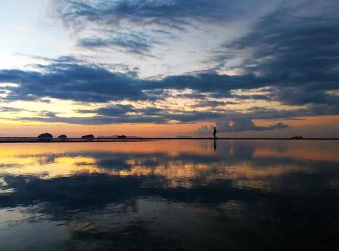 Fiery sunset with clouds by the ocean Stock Photos