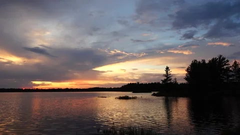 Fiery sunset with clouds over calm lake Video stock 156066308