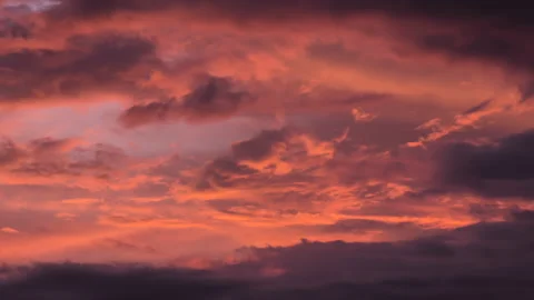 Fiery Sunset Cloudscape Transforming During Twilight. Dramatic Orange and Purple Stock Footage 309611863