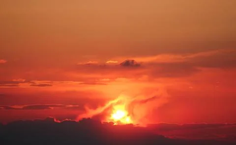 Fiery sunset, haze and clouds of a red tint. Stock Photos