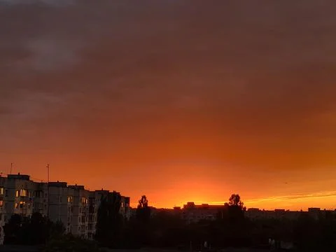 Fiery Sunset Over City Rooftops for Urban Architecture and Meteorology Design Stock Photos
