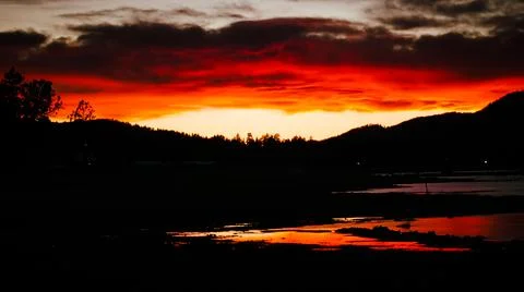 Fiery Sunset Over Mountains 库存照片