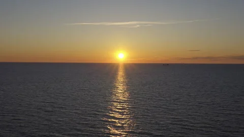 Fiery Sunset Over Still Ocean with Lone Ship and No Reflections (Slow Motion) Stock Footage 309420491