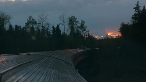 The Fiery Sunset reflects off the Passenger Train Stock Footage 92654418