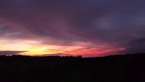 Fiery sunset, side-downward movement before Silhouette of trees, drone shot 스톡 동영상 140221264