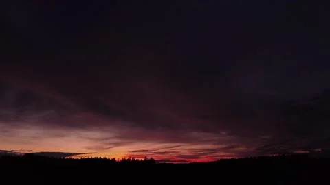 Fiery sunset, sideward left movement before Silhouette of trees, drone shot. Stock-Footage 140221012
