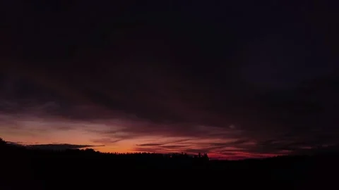 Fiery sunset, sideward upward movement before Silhouette of trees, drone shot Stock-Footage 140220813