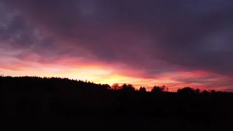Fiery sunset, sideward upward movement before Silhouette of trees, drone shot Stock-Footage 140221420